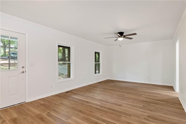 interior space featuring ceiling fan, crown molding, and light wood-type flooring