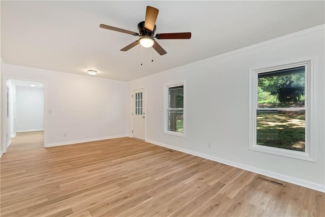 empty room featuring ornamental molding, ceiling fan, and light hardwood / wood-style flooring