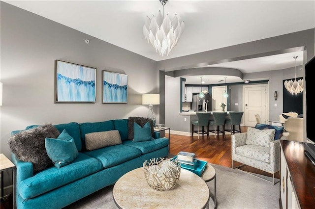 living room featuring an inviting chandelier and wood-type flooring