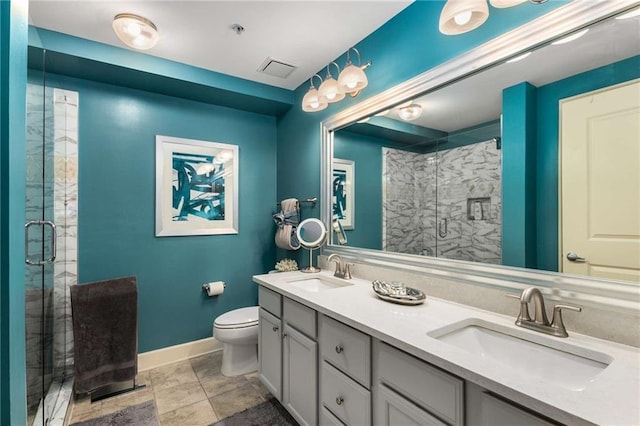 bathroom with vanity, a shower with shower door, and toilet