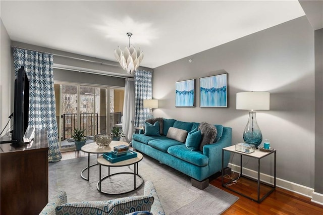 living room featuring an inviting chandelier and hardwood / wood-style floors