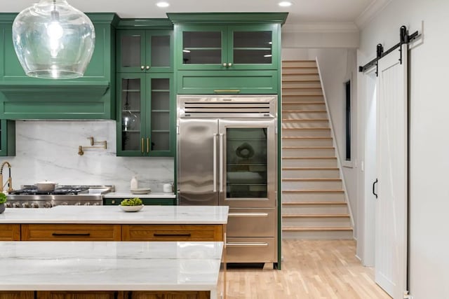 1430 N Harris Rdg, Atlanta, GA 30327 - kitchen with fridge, green cabinets, ornamental molding, decorative backsplash, and a barn door