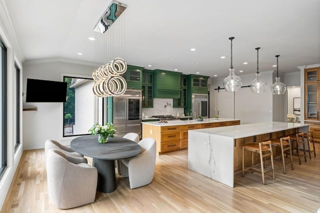 1430 N Harris Rdg, Atlanta, GA 30327 - kitchen with a large island, stainless steel appliances, light wood-style floors, tasteful backsplash, and crown molding