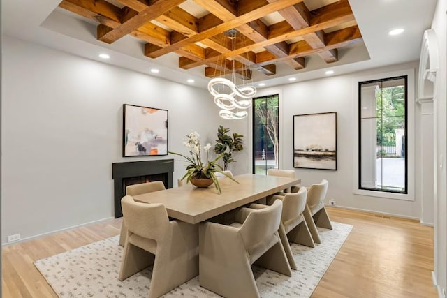 1430 N Harris Rdg, Atlanta, GA 30327 - dining area featuring coffered ceiling, beamed ceiling, light wood-style floors, a lit fireplace, and a chandelier