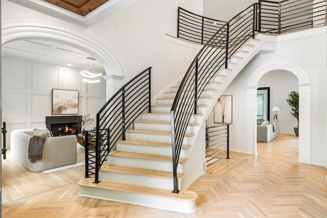 1430 N Harris Rdg, Atlanta, GA 30327 - stairs featuring a towering ceiling, a warm lit fireplace, and arched walkways