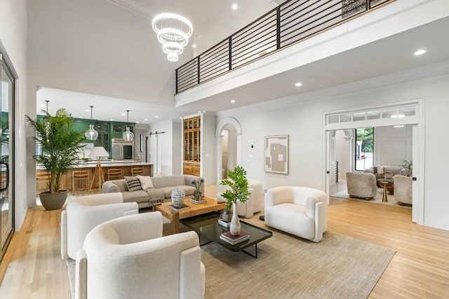 1430 N Harris Rdg, Atlanta, GA 30327 - living area featuring a high ceiling, light wood finished floors, a chandelier, crown molding, and recessed lighting