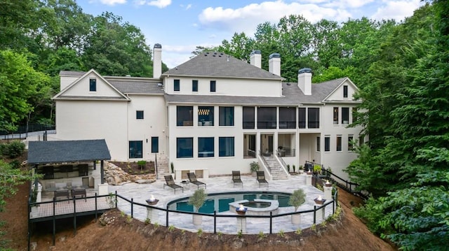 1430 N Harris Rdg, Atlanta, GA 30327 - rear view of house featuring stairs, a patio area, a chimney, stucco siding, and a pool with connected hot tub