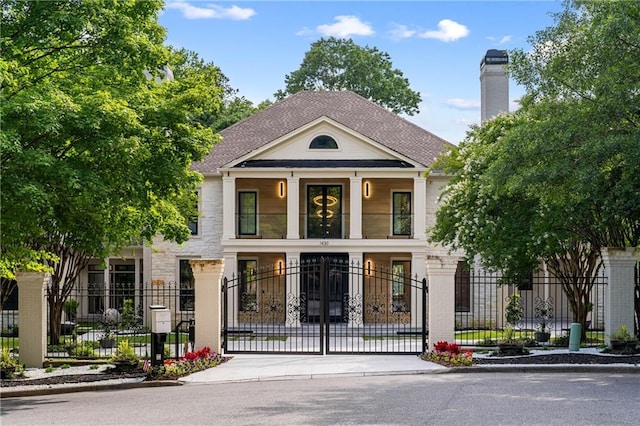 1430 N Harris Rdg, Atlanta, GA 30327 - greek revival house with a fenced front yard, a gate, a chimney, and stone siding