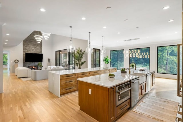 1430 N Harris Rdg, Atlanta, GA 30327 - kitchen featuring a spacious island, brown cabinets, light wood-type flooring, stainless steel appliances, and recessed lighting