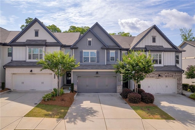 5615 Parkview Ln, Flowery Branch, GA 30542 - view of front of house with board and batten siding, an attached garage, and driveway