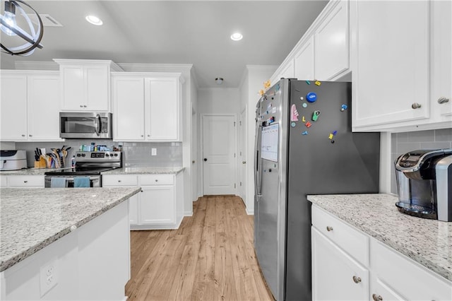5615 Parkview Ln, Flowery Branch, GA 30542 - kitchen featuring appliances with stainless steel finishes, white cabinets, light wood-type flooring, tasteful backsplash, and recessed lighting