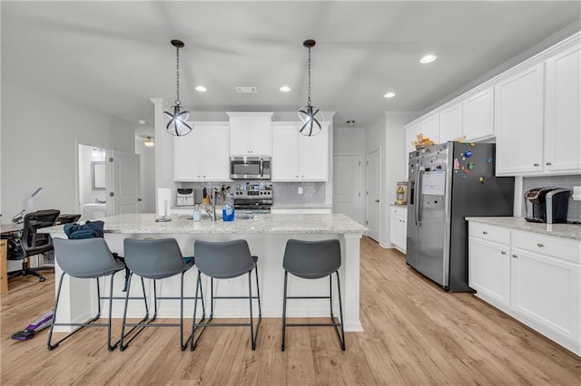 5615 Parkview Ln, Flowery Branch, GA 30542 - kitchen featuring stainless steel appliances, decorative backsplash, white cabinetry, and recessed lighting