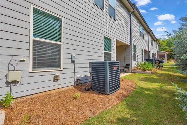 5615 Parkview Ln, Flowery Branch, GA 30542 - view of property exterior featuring a central AC unit and a lawn