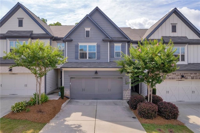 5615 Parkview Ln, Flowery Branch, GA 30542 - view of front of home featuring board and batten siding, an attached garage, driveway, and stone siding