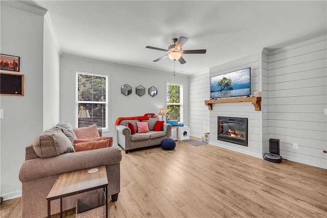 5615 Parkview Ln, Flowery Branch, GA 30542 - living area with crown molding, a fireplace, a ceiling fan, light wood-type flooring, and wood walls