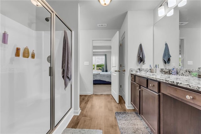 5615 Parkview Ln, Flowery Branch, GA 30542 - ensuite bathroom featuring vanity, wood finished floors, and a shower stall