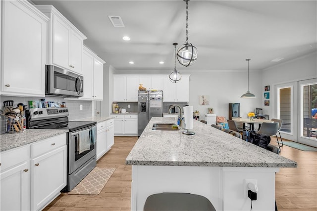 5615 Parkview Ln, Flowery Branch, GA 30542 - kitchen featuring appliances with stainless steel finishes, a center island with sink, recessed lighting, backsplash, and white cabinets