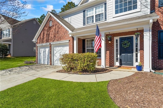 view of front of home featuring an attached garage, driveway, a front lawn, and brick siding