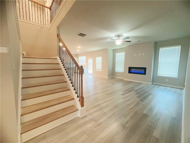 unfurnished living room with hardwood / wood-style floors and ceiling fan