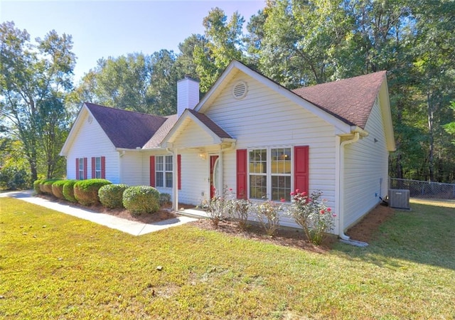 view of front of property with a front lawn and central air condition unit