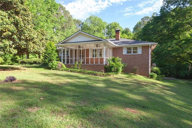 5670 Lanny Dr, Powder Springs, GA 30127 - view of front facade with a chimney, brick siding, a front lawn, a sunroom, and ceiling fan