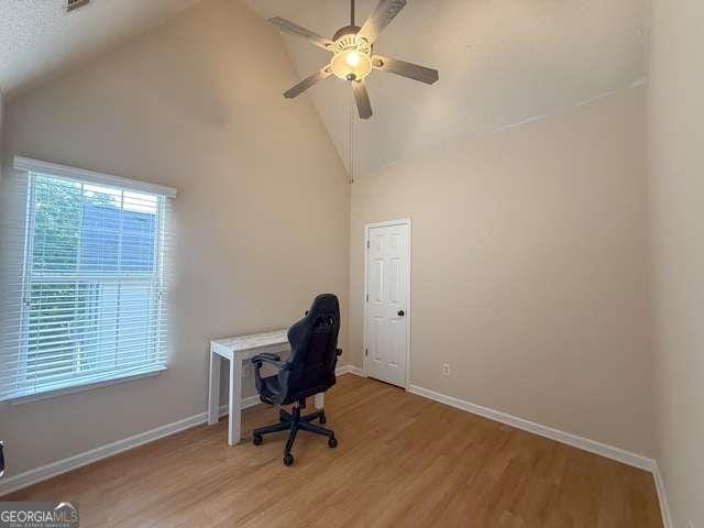 3269 N Winds Trl N, Douglasville, GA 30135 - unfurnished office with light wood finished floors, ceiling fan, baseboards, and high vaulted ceiling