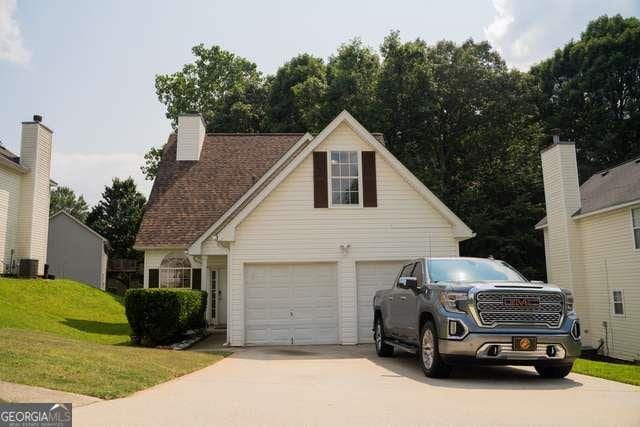 3269 N Winds Trl N, Douglasville, GA 30135 - view of property exterior featuring concrete driveway, a garage, and a lawn