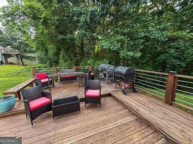 3269 N Winds Trl N, Douglasville, GA 30135 - wooden deck with an outdoor living space and grilling area