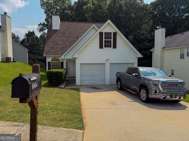 3269 N Winds Trl N, Douglasville, GA 30135 - view of front facade with a garage, a front yard, and driveway