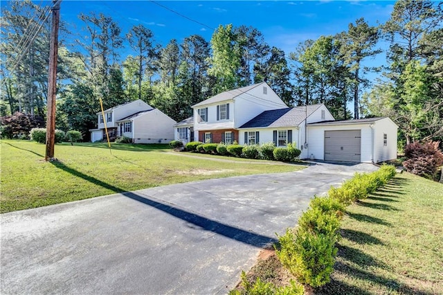 view of front of home with a garage and a front yard