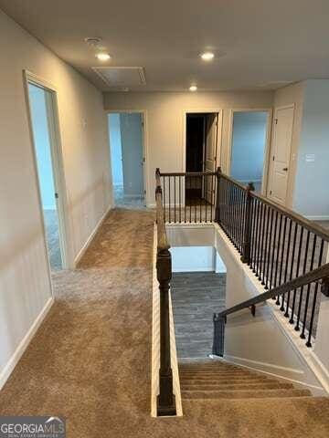 hallway with carpet flooring