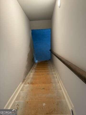 stairs with wood-type flooring