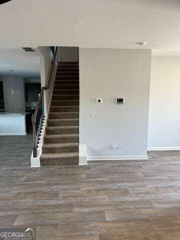 stairway with hardwood / wood-style floors