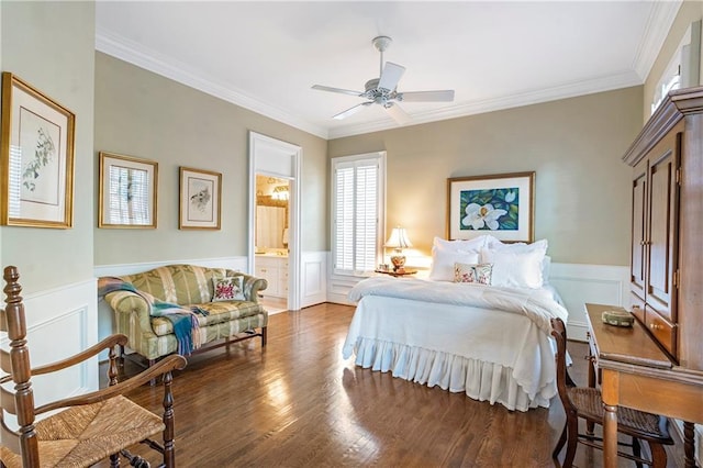 bedroom featuring crown molding, ensuite bathroom, wood finished floors, and wainscoting