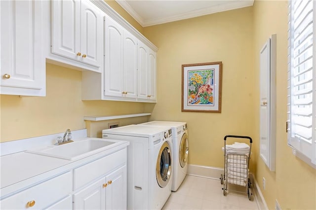 laundry room with cabinet space, baseboards, ornamental molding, washing machine and clothes dryer, and a sink