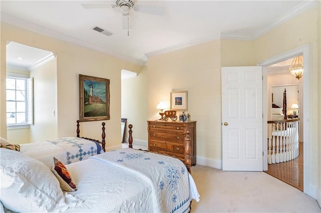 carpeted bedroom with ornamental molding, visible vents, ceiling fan, and baseboards