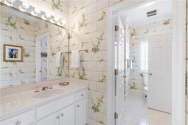 bathroom with visible vents, vanity, toilet, and wallpapered walls