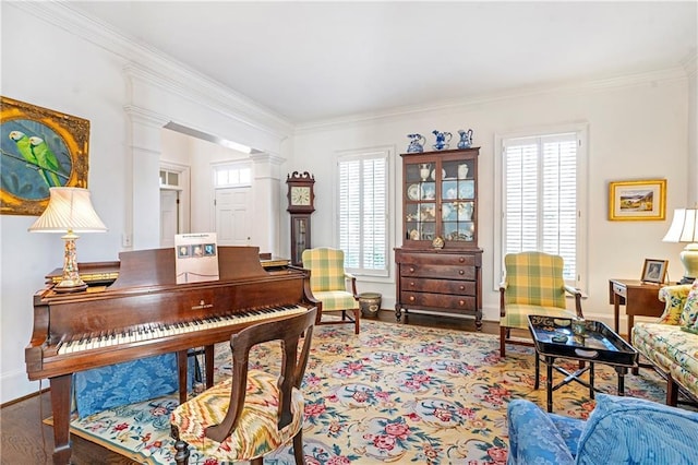 office featuring baseboards, wood finished floors, decorative columns, and crown molding