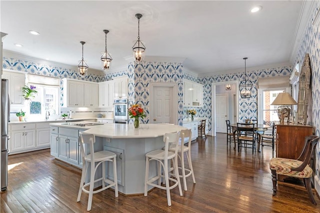 kitchen with ornamental molding, plenty of natural light, white cabinetry, and wallpapered walls