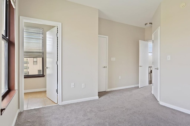 unfurnished bedroom with light carpet