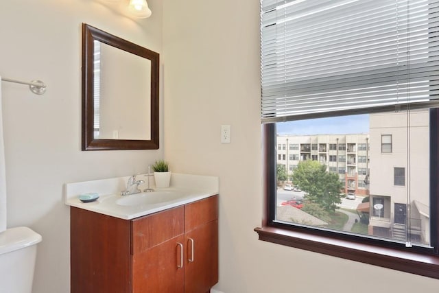 bathroom featuring vanity and toilet