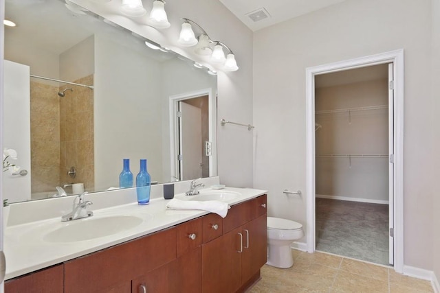 full bathroom with tile patterned flooring, vanity, tiled shower / bath combo, and toilet