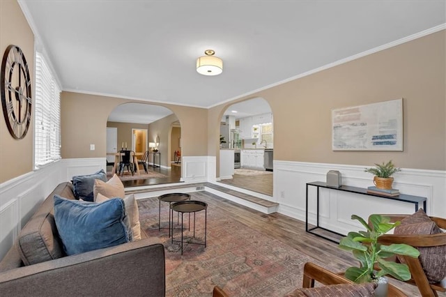 living room featuring wood-type flooring and ornamental molding