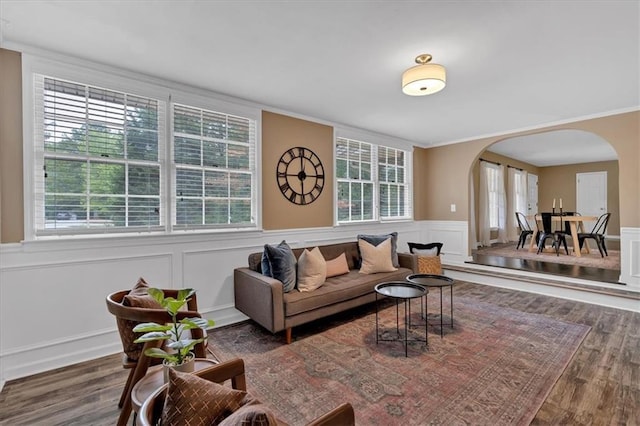 living room with dark hardwood / wood-style flooring and ornamental molding