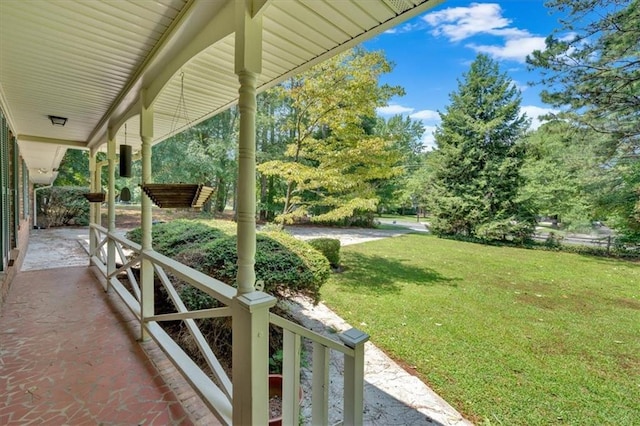 view of yard featuring covered porch