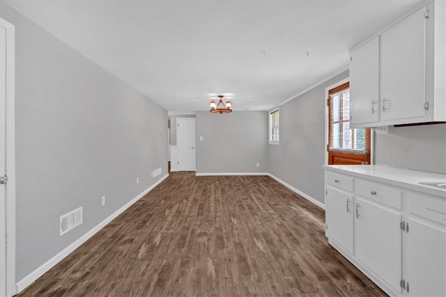 interior space with dark hardwood / wood-style floors and a chandelier