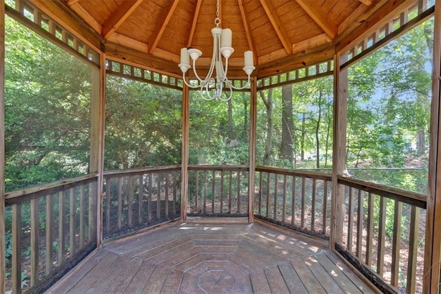 unfurnished sunroom with an inviting chandelier and lofted ceiling