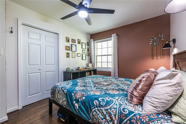 bedroom with a closet, dark wood-type flooring, and ceiling fan