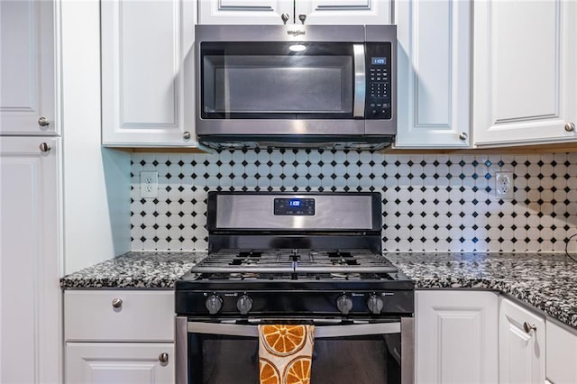 kitchen with backsplash, white cabinetry, and stainless steel appliances