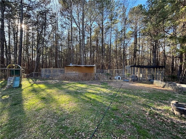 view of yard featuring fence and an outdoor structure